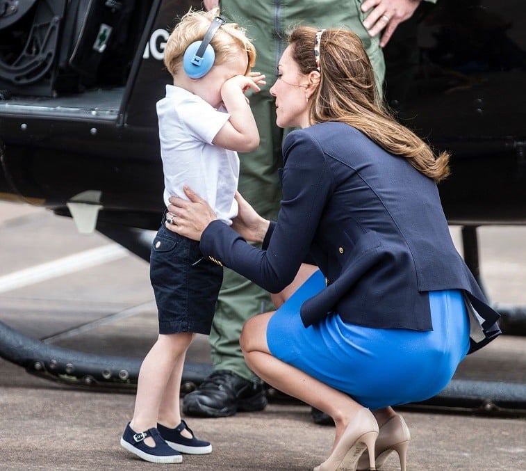 Britain's Prince George rubs his eyes as he speaks with his mother Catherine, Duchess of Cambridge, during a visit to the Royal International Air Tattoo at RAF Fairford in western England, on July 8, 2016. Britain's Prince George rubs his eyes as he speaks with his mother Catherine, Duchess of Cambridge, during a visit to the Royal International Air Tattoo at RAF Fairford in western England, on July 8, 2016.