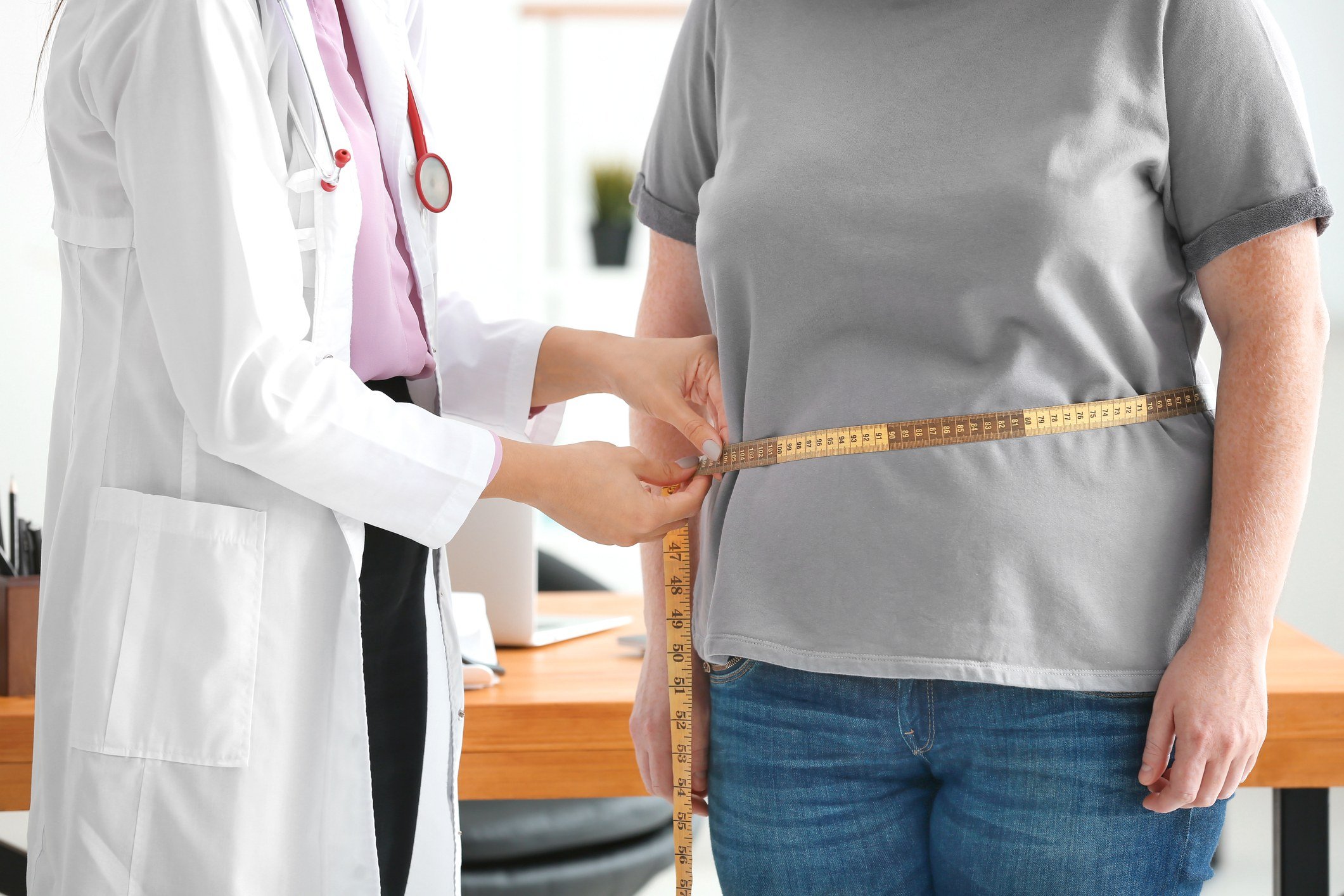 An overweight woman visits a doctor.