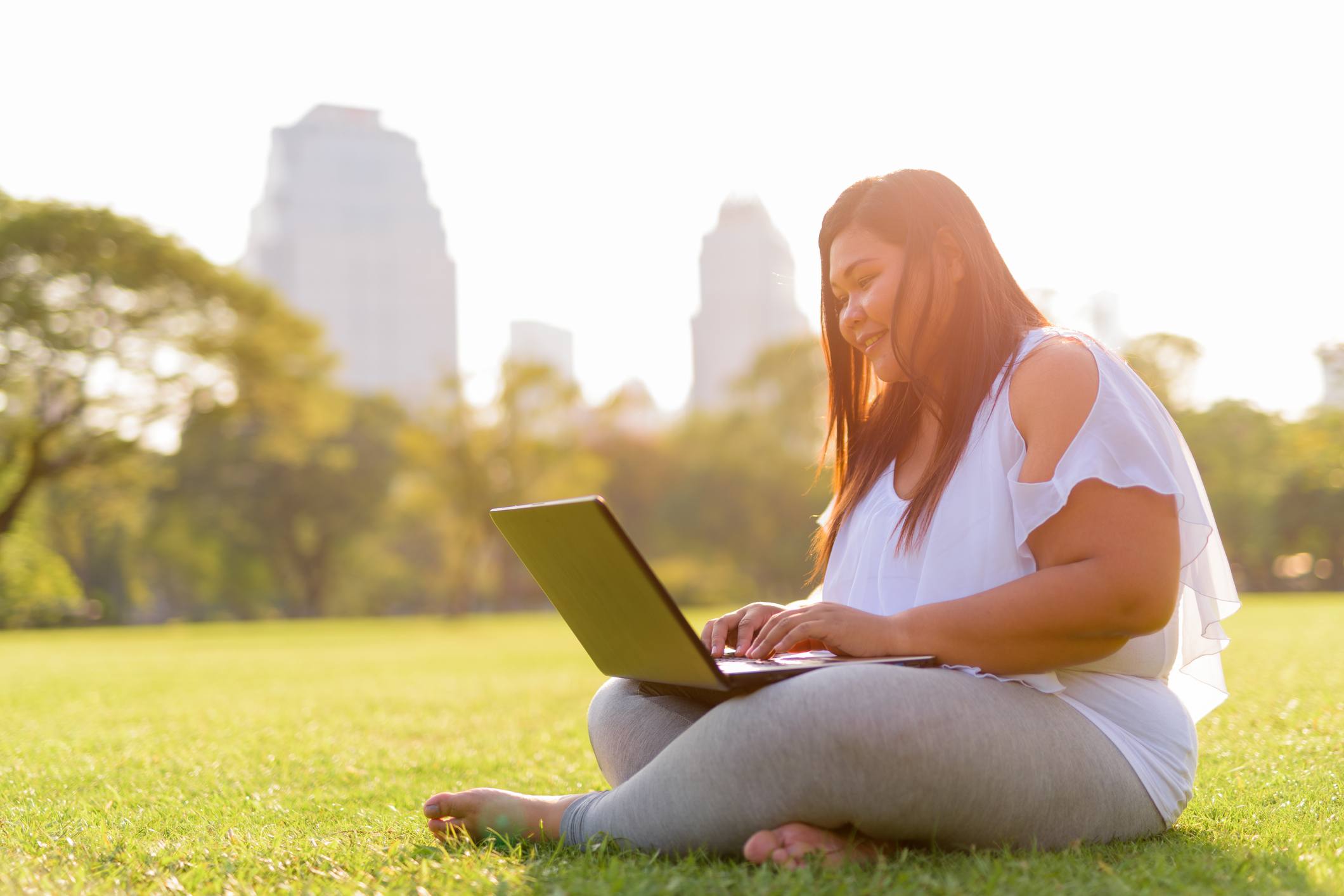 Overweight woman working on her computer
