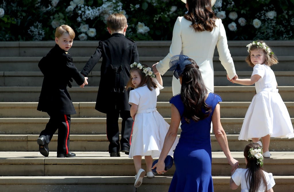 The royal wedding party heads up the steps to the church.