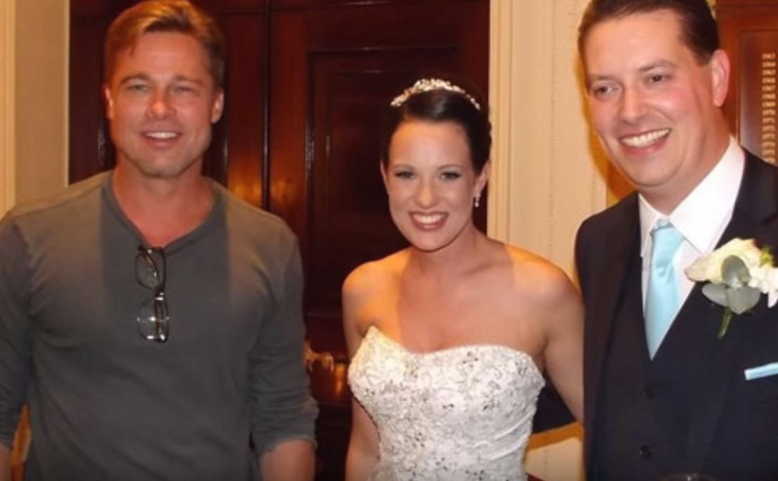 Brad Pitt poses with the newlyweds.