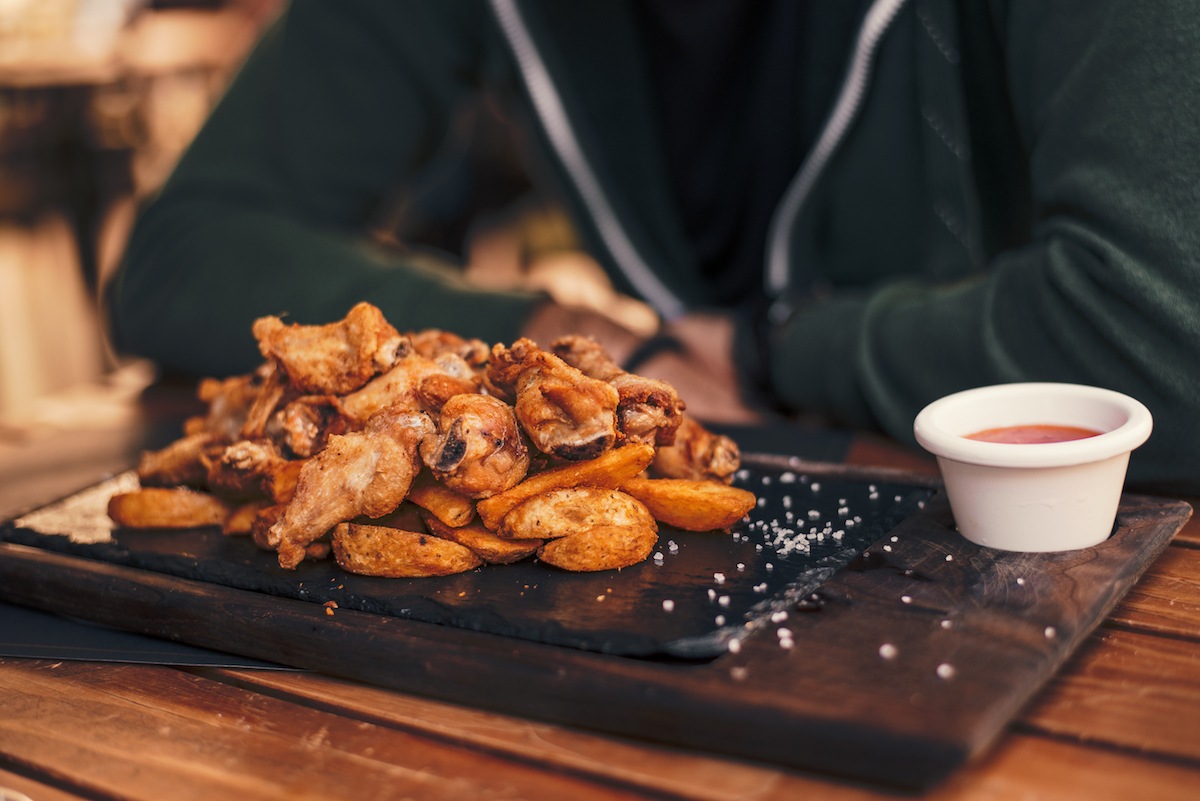 Customer with chicken wings at a restaurant