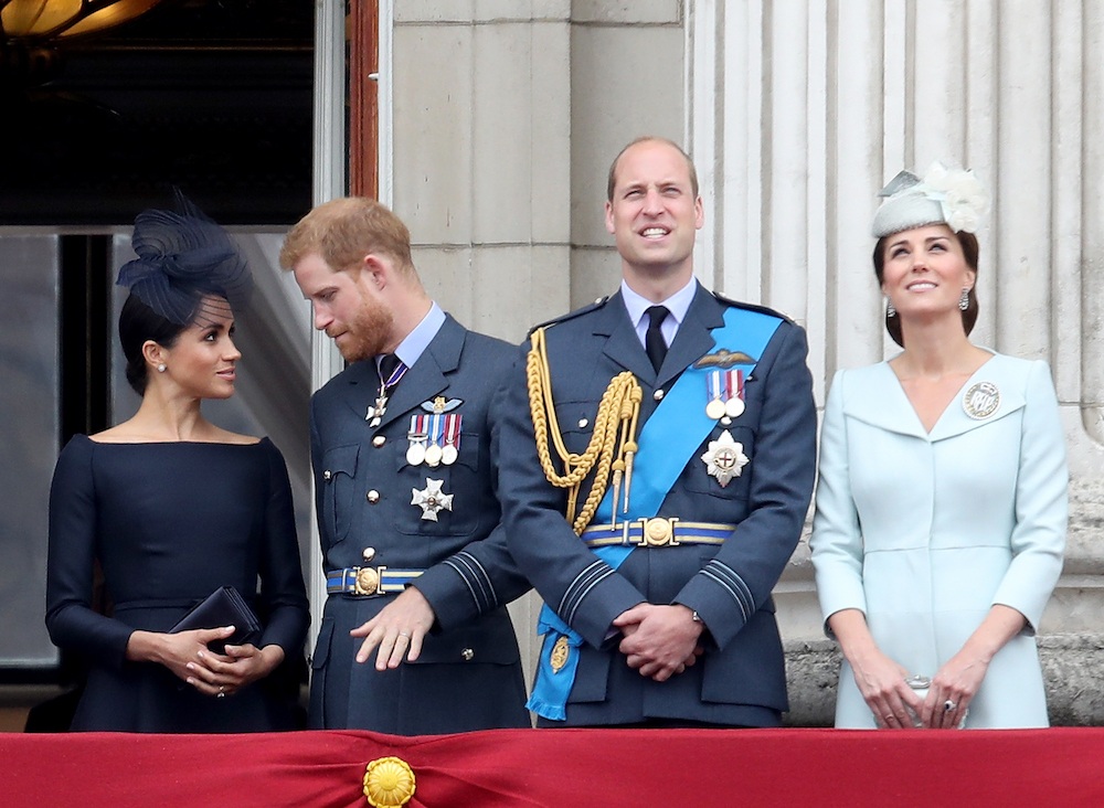 Meghan Markle, Prince Harry, Prince William, and Kate Middleton watch the RAF flypast on the balcony of Buckingham Palace