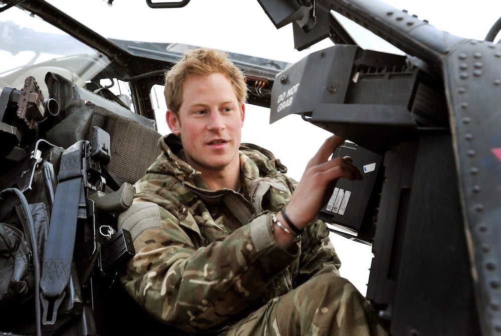 Prince Harry makes early morning checks as he sits on an Apache helicopter