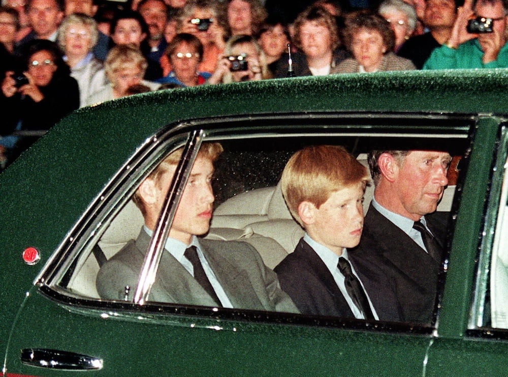 Prince William, Prince Harry, and Prince Charles follow the hearse in a limousine the night before Princess Diana's funeral
