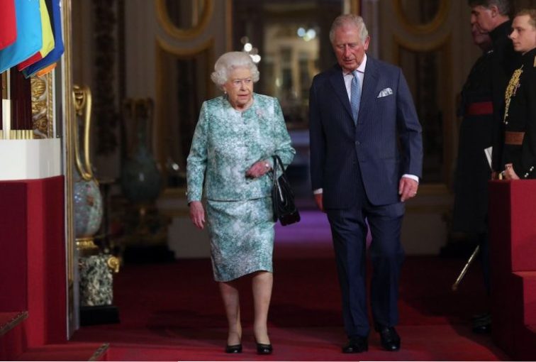 Queen Elizabeth II and Prince Charles arrive for the formal opening of the Commonwealth Heads of Government Meeting at the ballroom at Buckingham Palace