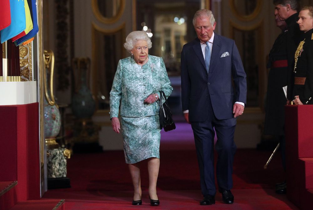 Queen Elizabeth II and Prince Charles arrive for the formal opening of the Commonwealth Heads of Government Meeting at the ballroom at Buckingham Palace