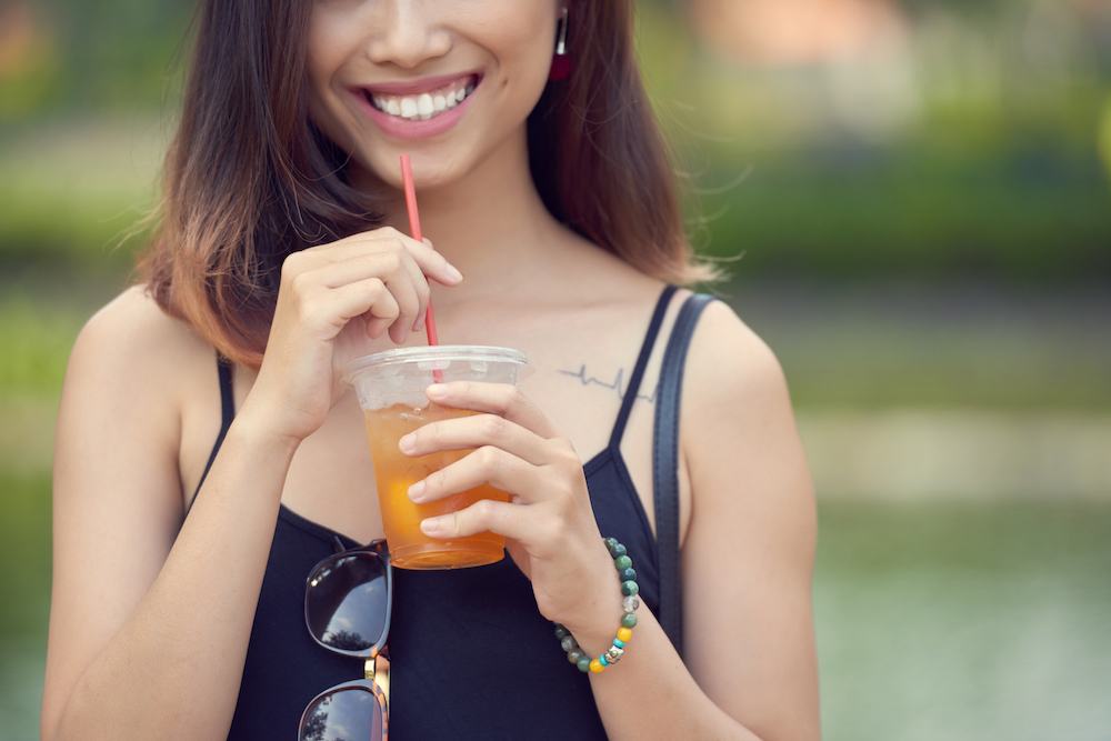 Woman holding cup of iced tea Woman holding cup of iced tea
