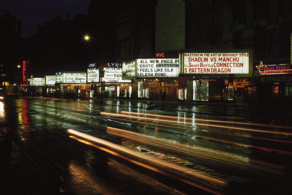 Cinema signs advertising adult and martial arts films on 42nd Street, New York, circa 1977 