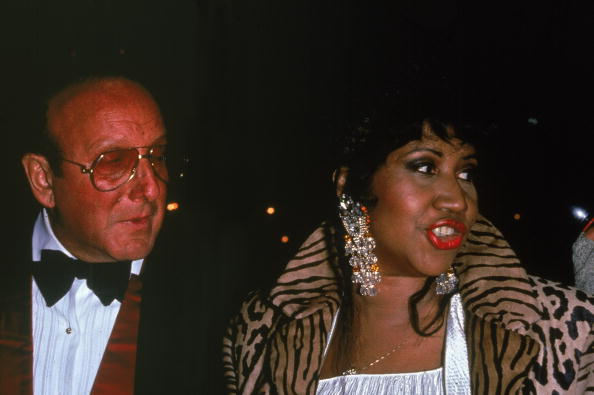 American music executive Clive Davis and American soul singer Aretha Franklin attend an event, 1992. Franklin wears a leopard fur coat