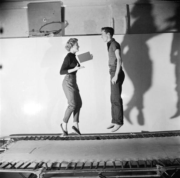 A couple bouncing on a trampoline A couple bouncing on a trampoline