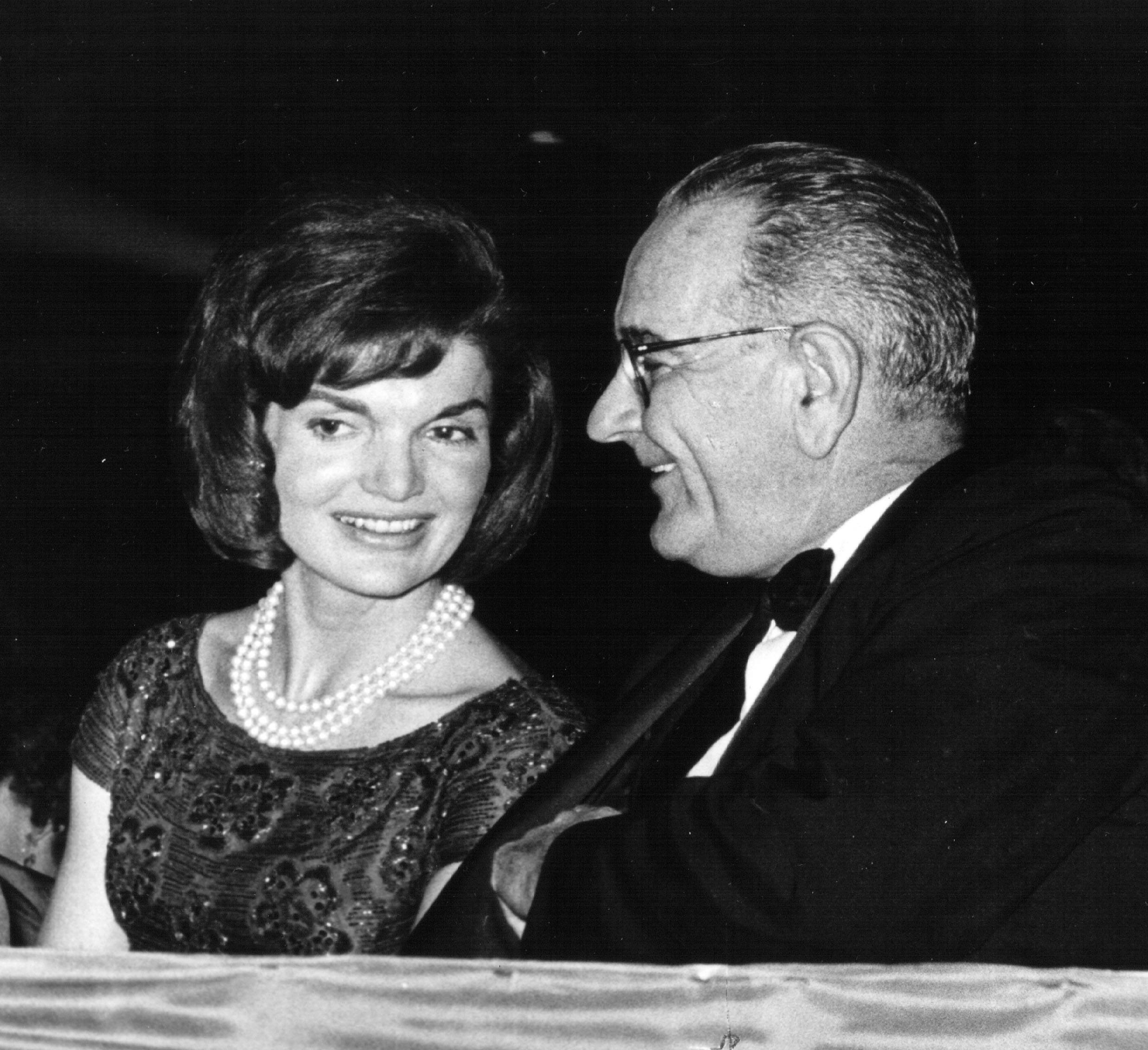 First Lady Jackie Kennedy speaks with Vice President Lyndon B. Johnson during a ceremony January 18, 1963 in Washington, DC
