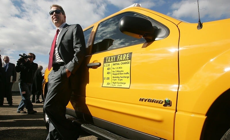 NEW YORK - NOVEMBER 10: Ford Chairman and CEO Bill Ford leans against a Ford Escape Hybrid taxicab which was unveiled today as one of the first six hybrid taxis in the city November 10, 2005 in New York City. The Escape Hybrid taxis run on a combination of gasoline and electricity and achieve 36 miles per gallon in city driving, close to 500 miles per tank of gas.