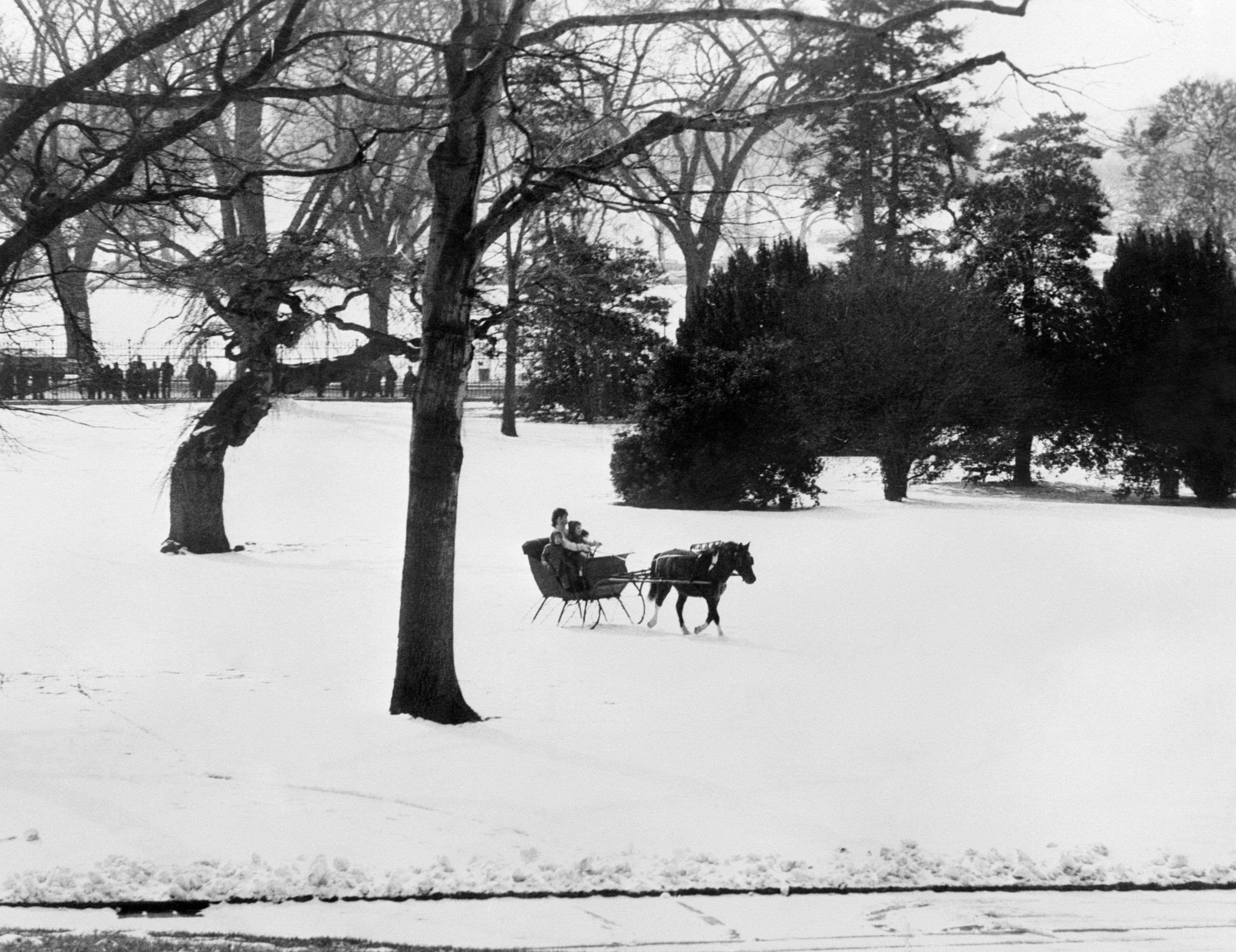 Jacqueline Kennedy takes a a sleigh ride with her children John F. Kennedy, Jr. and Caroline Kennedy
