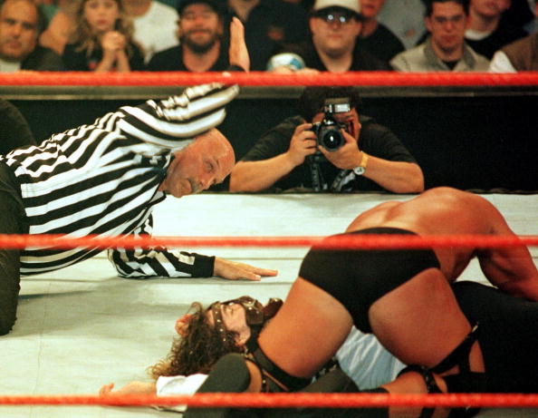 Minnesota Governor, former professional wrestler and guest referee Jesse Ventura (L) administers the three count Minnesota Governor, former professional wrestler and guest referee Jesse Ventura (L) administers the three count