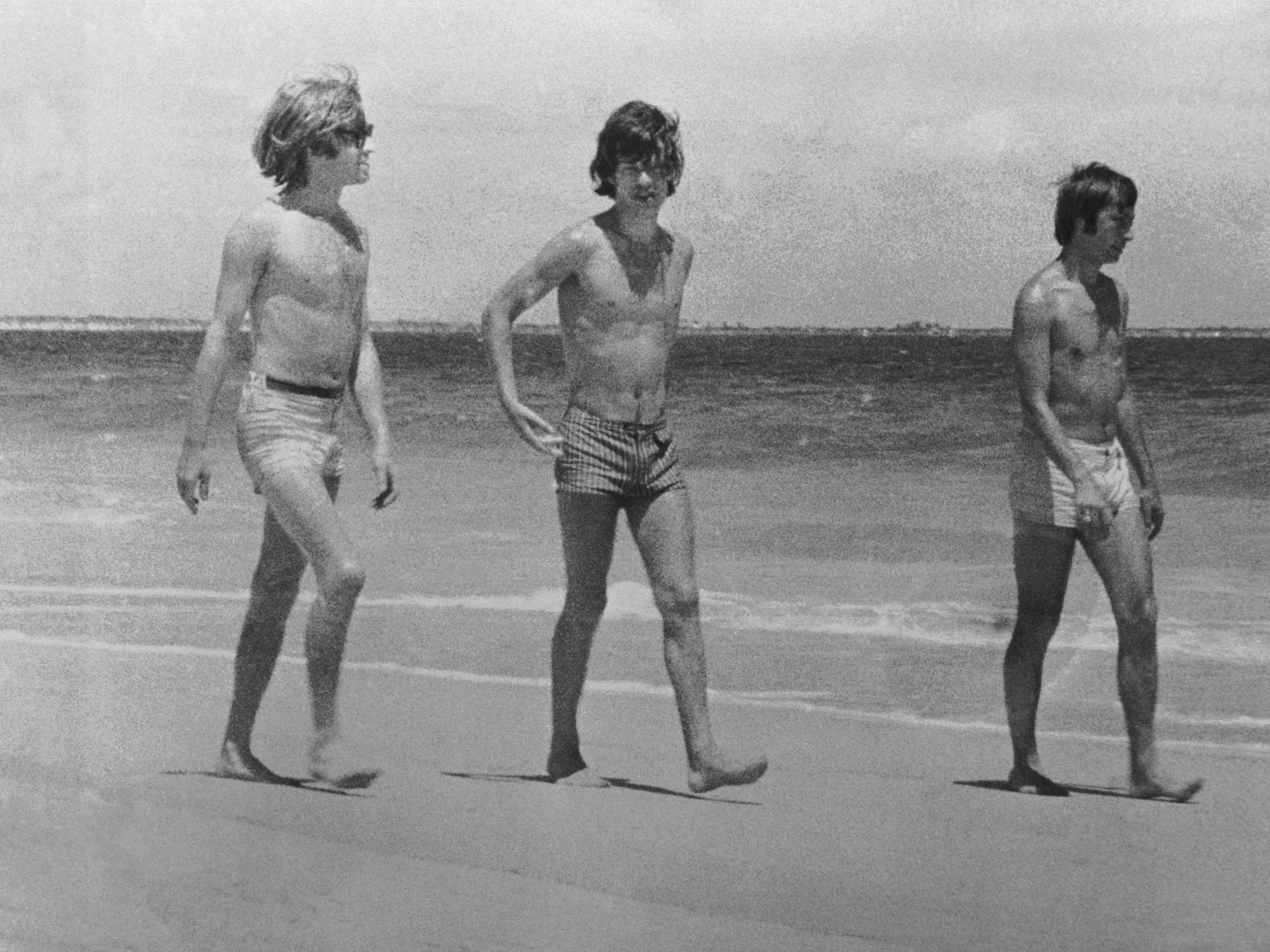 Rolling Stones Brian Jones, Mick Jagger and Charlie Watts on the beach in Australia, 1965