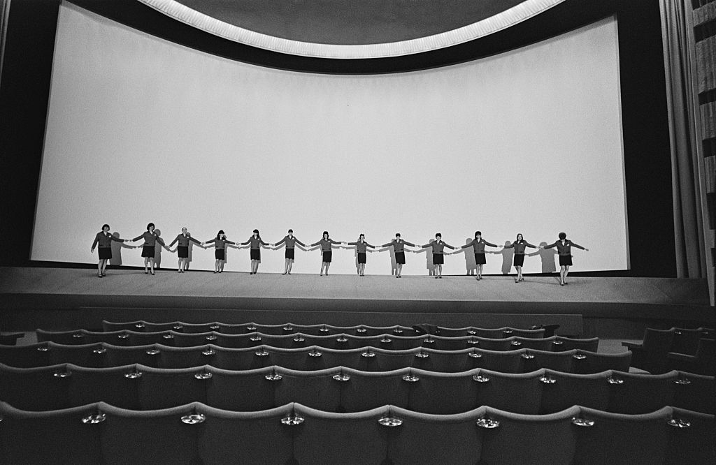 Staff holding hands in front of the screen at the Odeon cinema at Marble Arch, London, 28th January 1967