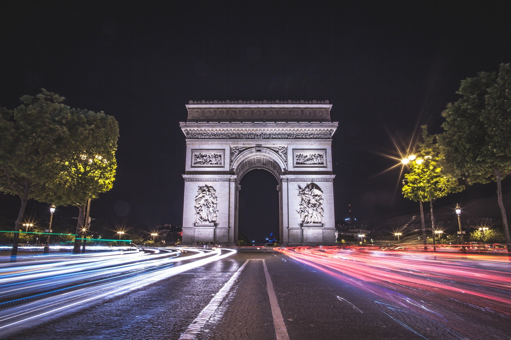 A long exposure photo centered on the famous Arc de Triomphe with traffic passing. 2017 Paris, France