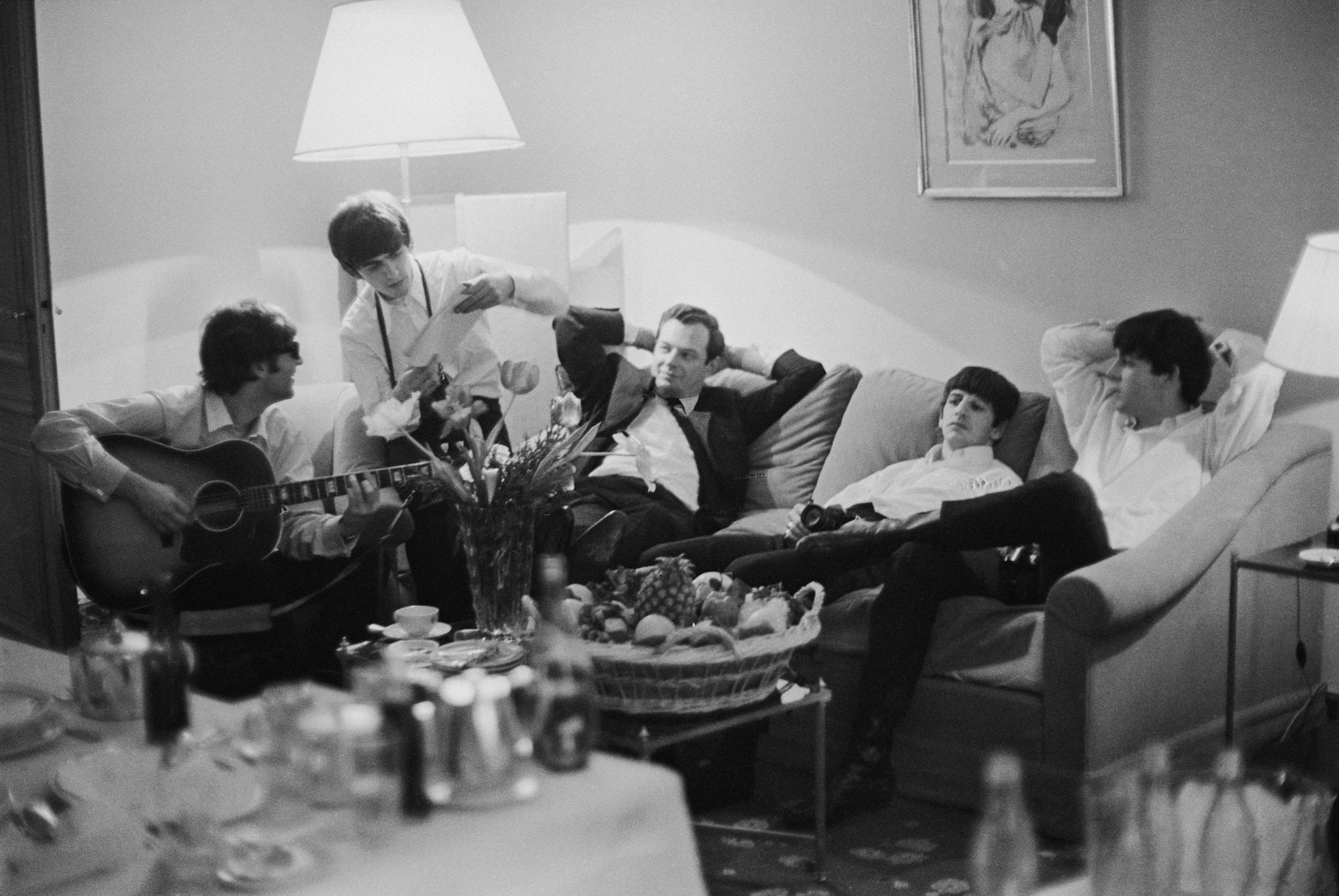 The Beatles relax in a hotel room in Paris, 16th January 1964.