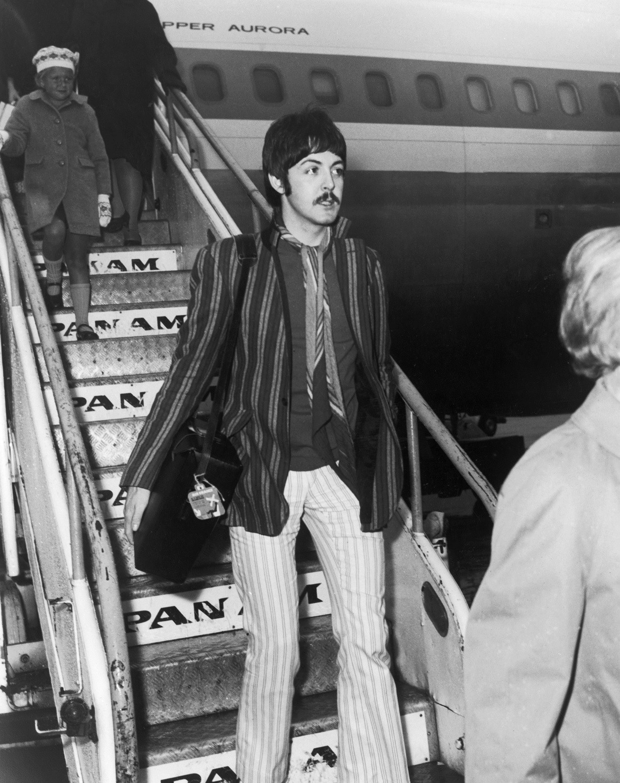 Paul McCartney of the Beatles steps off a Pan Am flight at London Airport