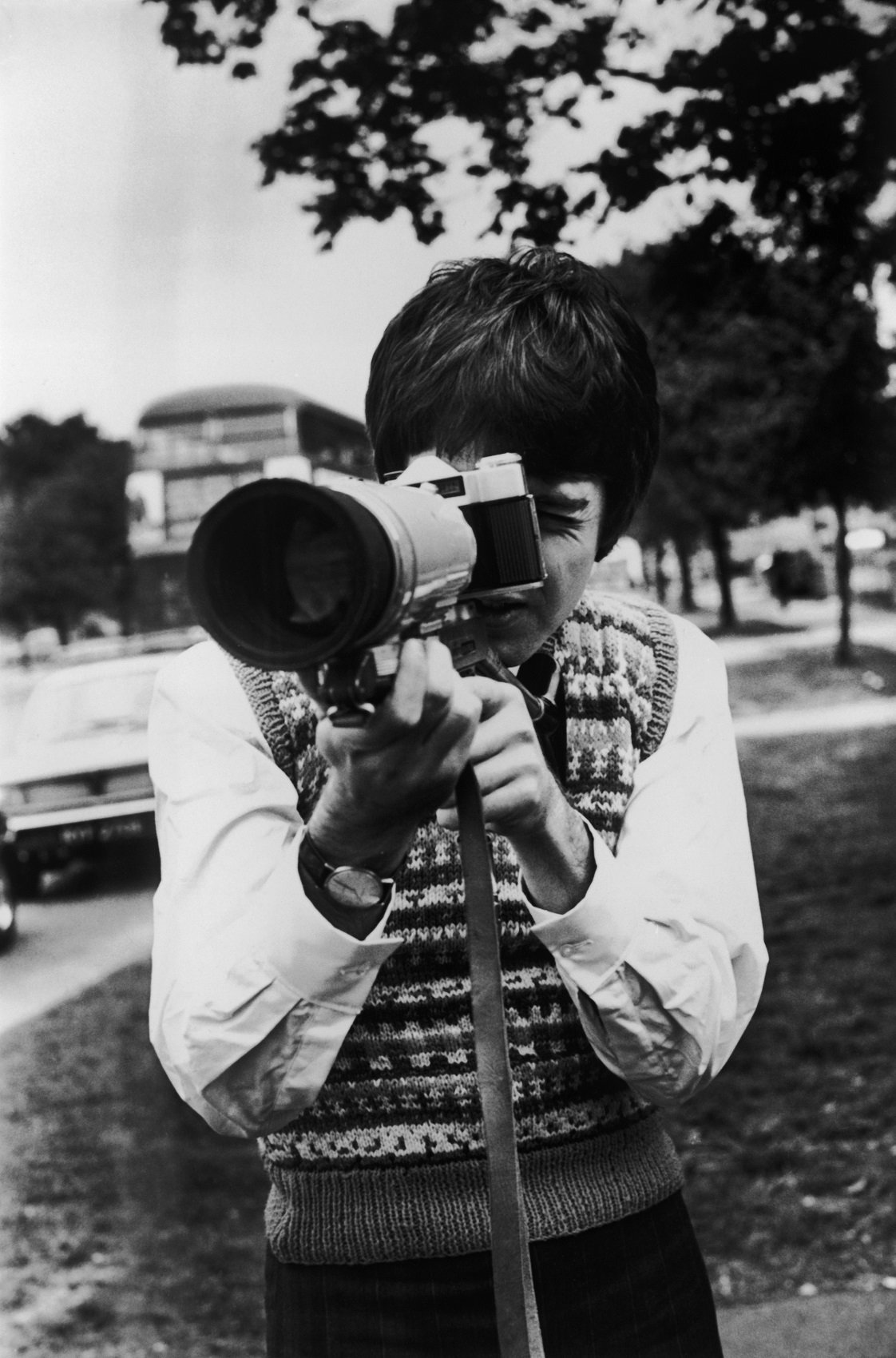 Paul McCartney takes some shots with a Russian Zenit Photo-Sniper camera outfit while waiting for the Magical Mystery Tour bus.