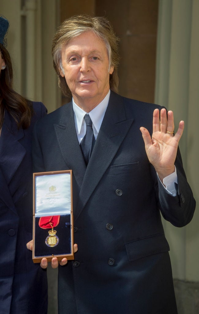 Sir Paul McCartney poses following an Investiture ceremony