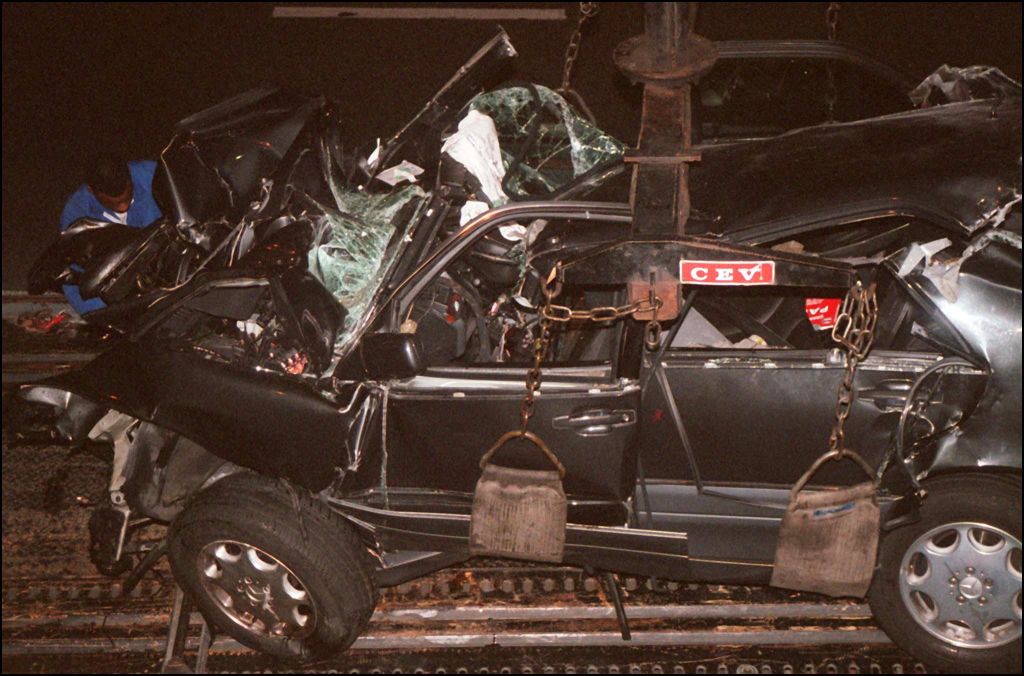 A French policeman attaches the wreckage of Princess Diana's car 3