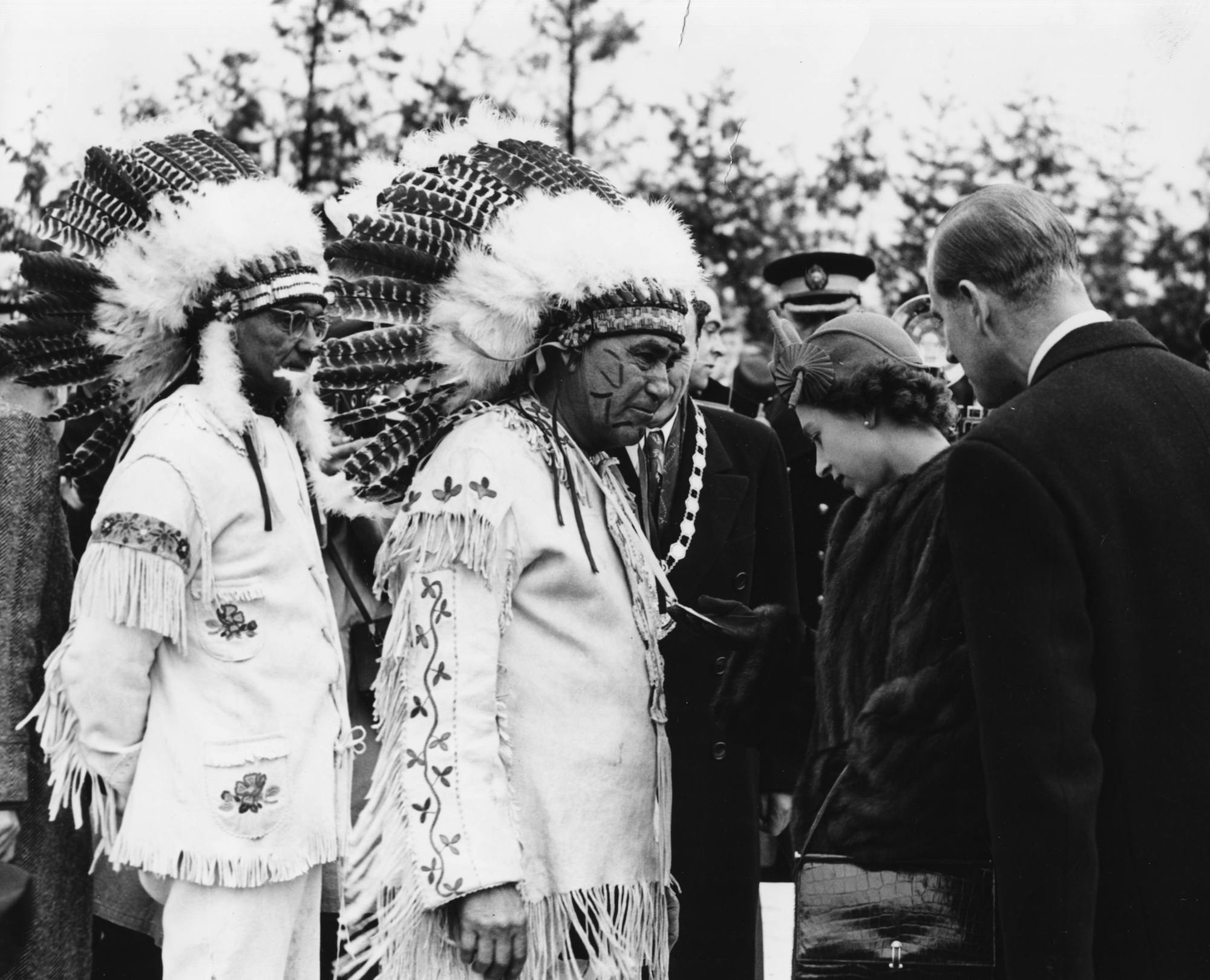 Princess Elizabeth and Prince Philip greet a group of Native American Chiefs at Fort William in Canada