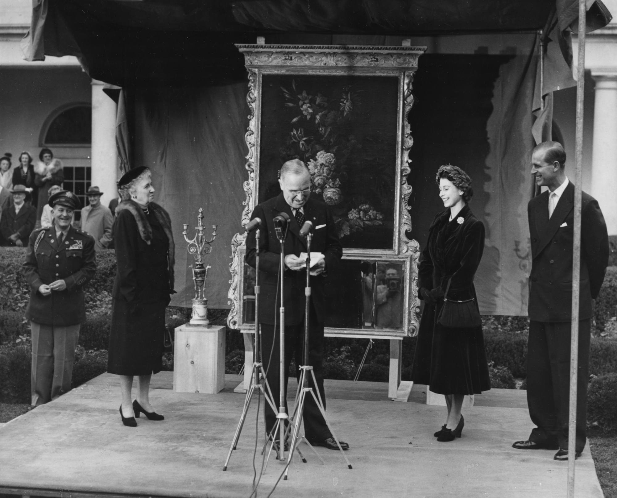 Princess Elizabeth and Prince Philip smile as Harry S. Truman gives a speech in Washington, D.C.