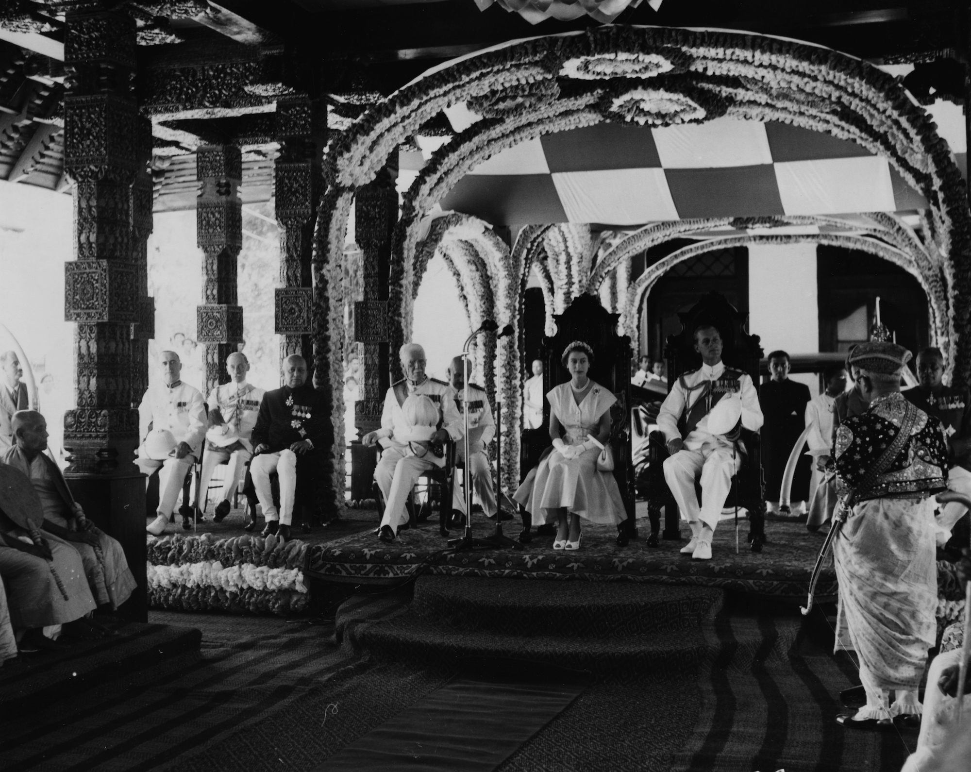 Queen Elizabeth II and Prince Philip listen to the Adigar, Sir Tikiri Bandara Panabokke II in Kandy, Ceylon, later Sri Lanka