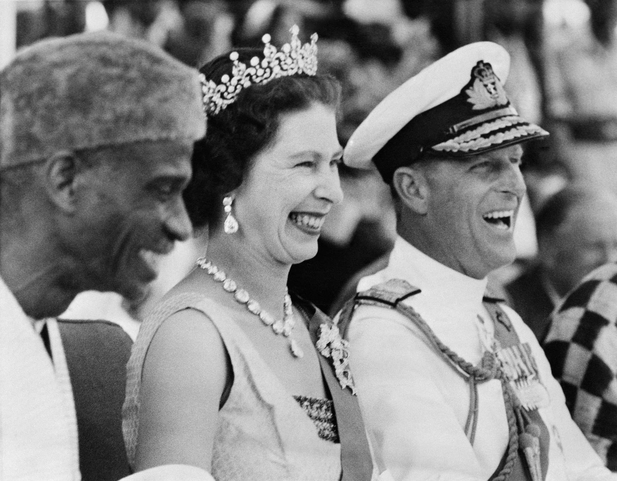 Queen Elizabeth II and Prince Philip watch the Susu dancers during their visit at the Northern Province of Sierra Leone