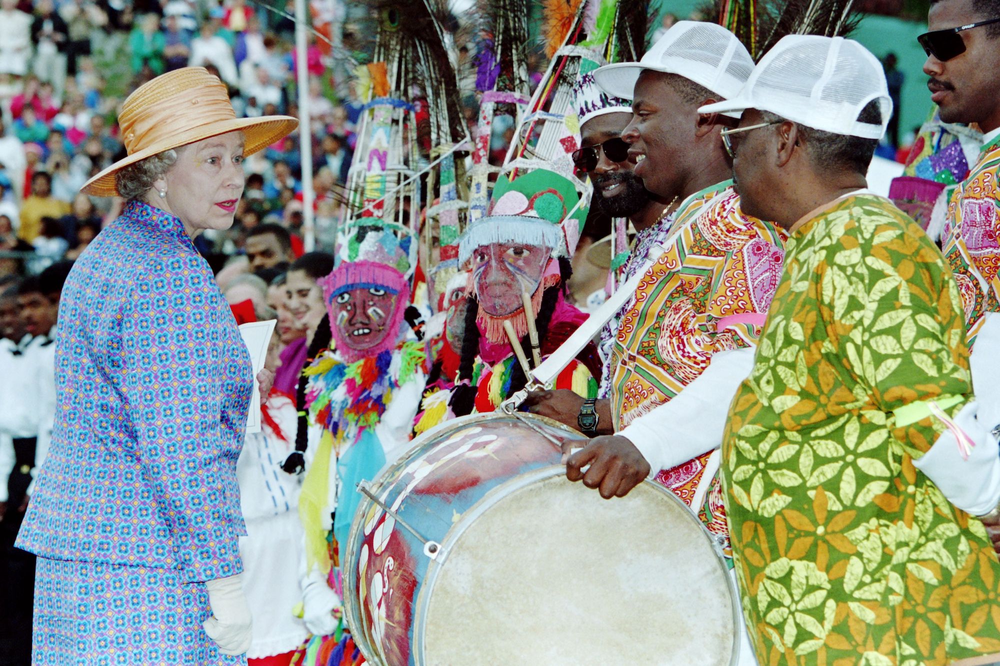 Queen Elizabeth II talks with a native Bermudian dance troop