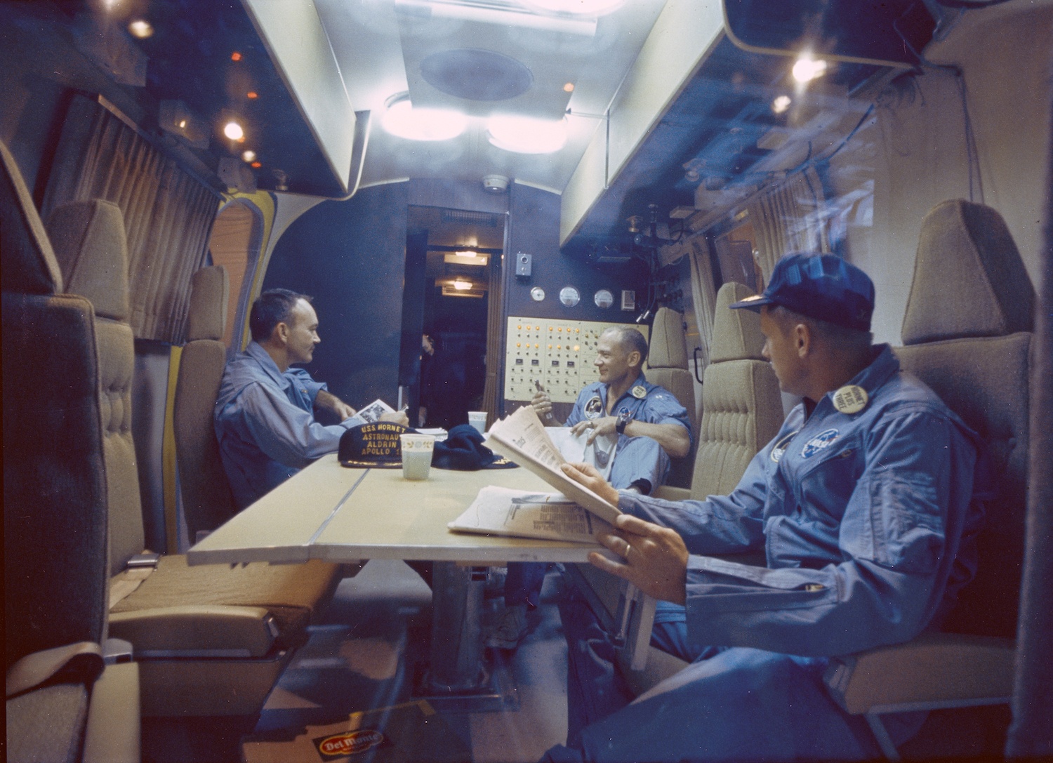 The Apollo 11 crew inside the mobile quarantine facility after their return to earth