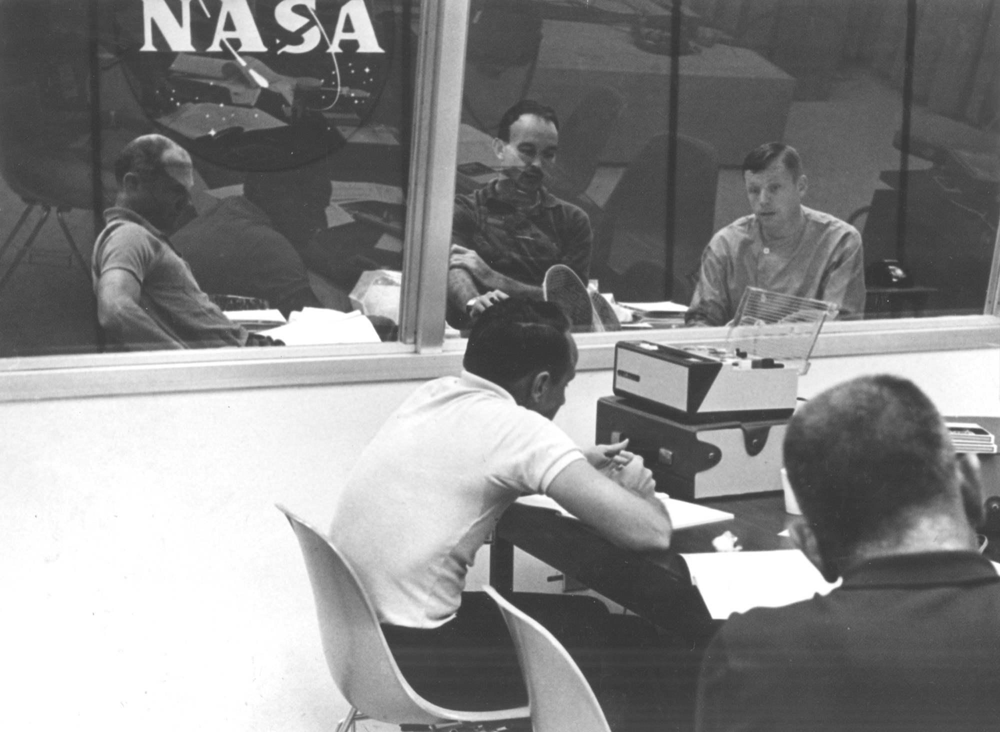 The Apollo 11 crew undergoes their first debriefing