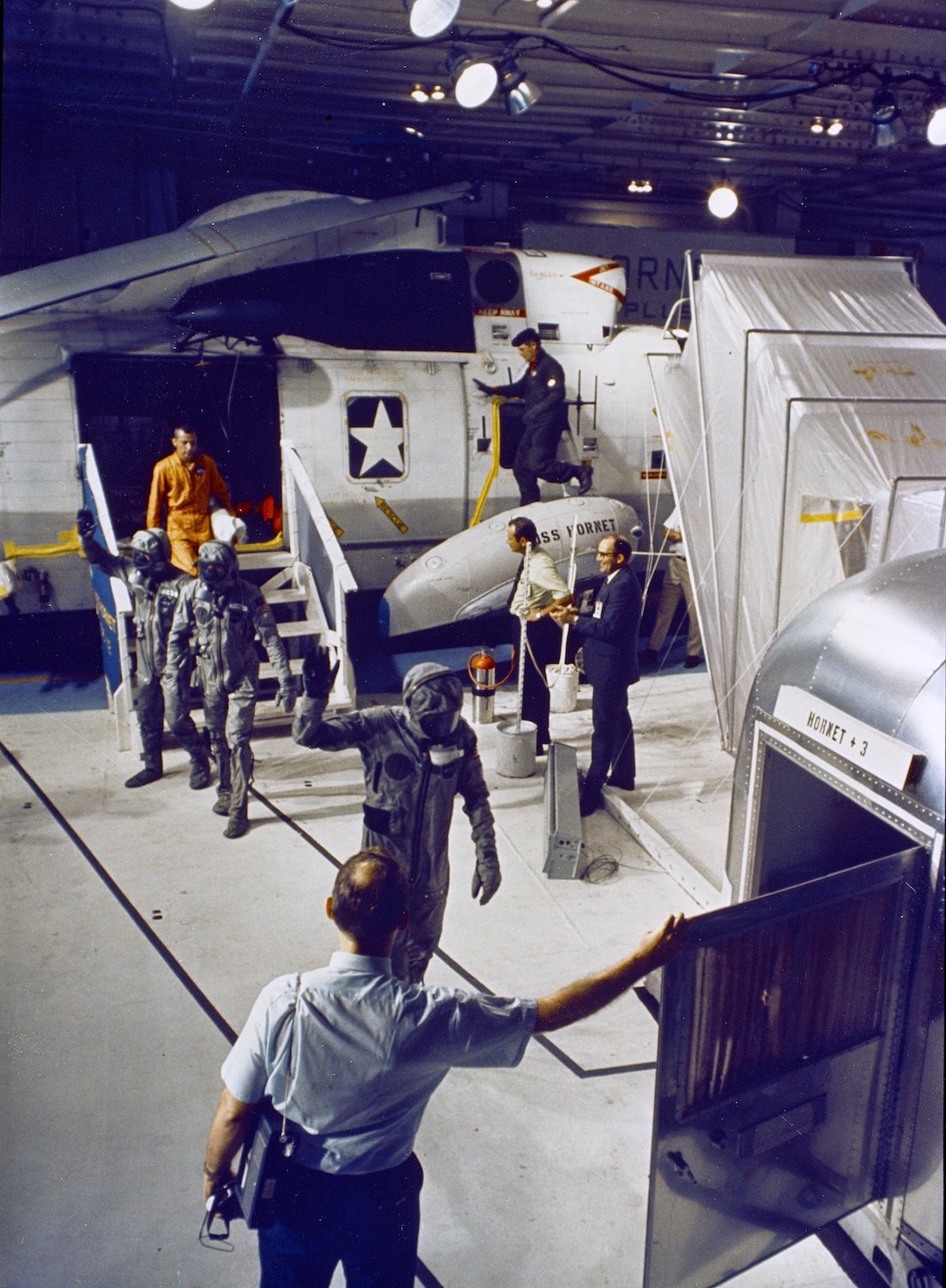 The Apollo 11 crew walks to a mobile quarantine facility