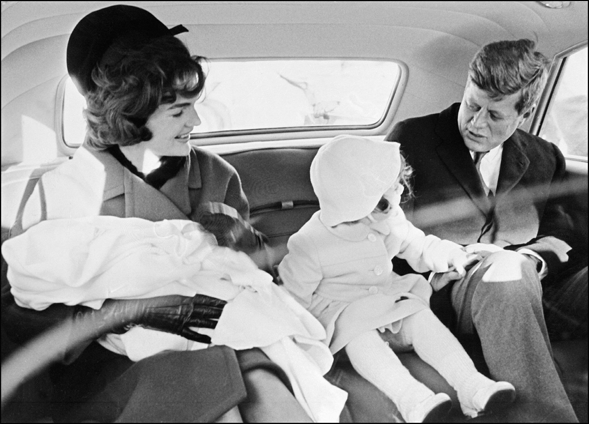 The Kennedy family sits in the presidential car