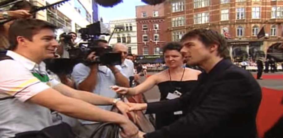Tom Cruise with a reporter who squirted him with water