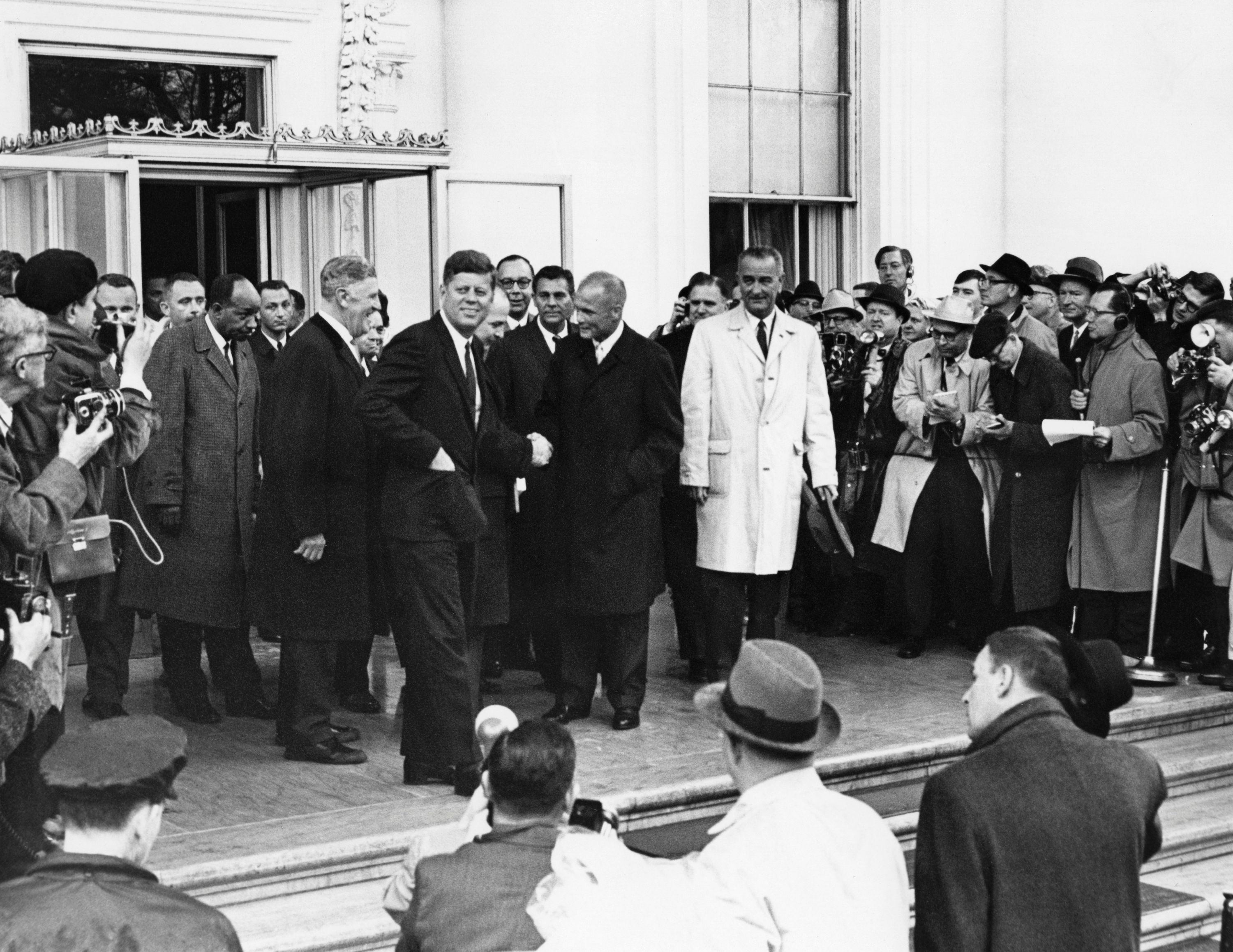 U.S. astronaut John Glenn leaves the White House with John F. Kennedy and Lyndon B. Johnson