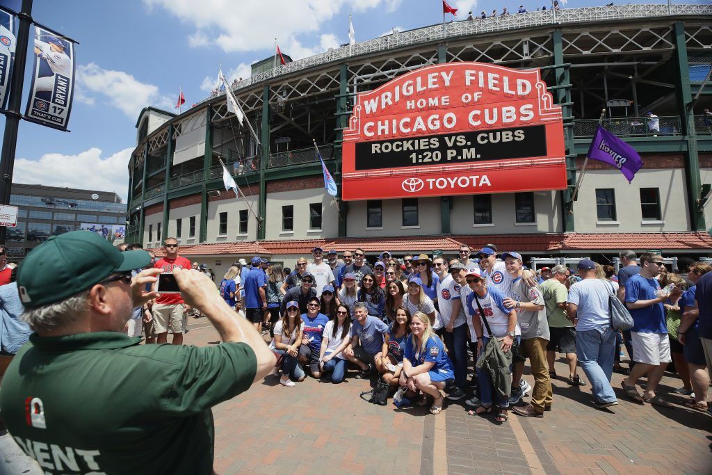 Fans have their picture taken in front of the marquee at Wrigley Field