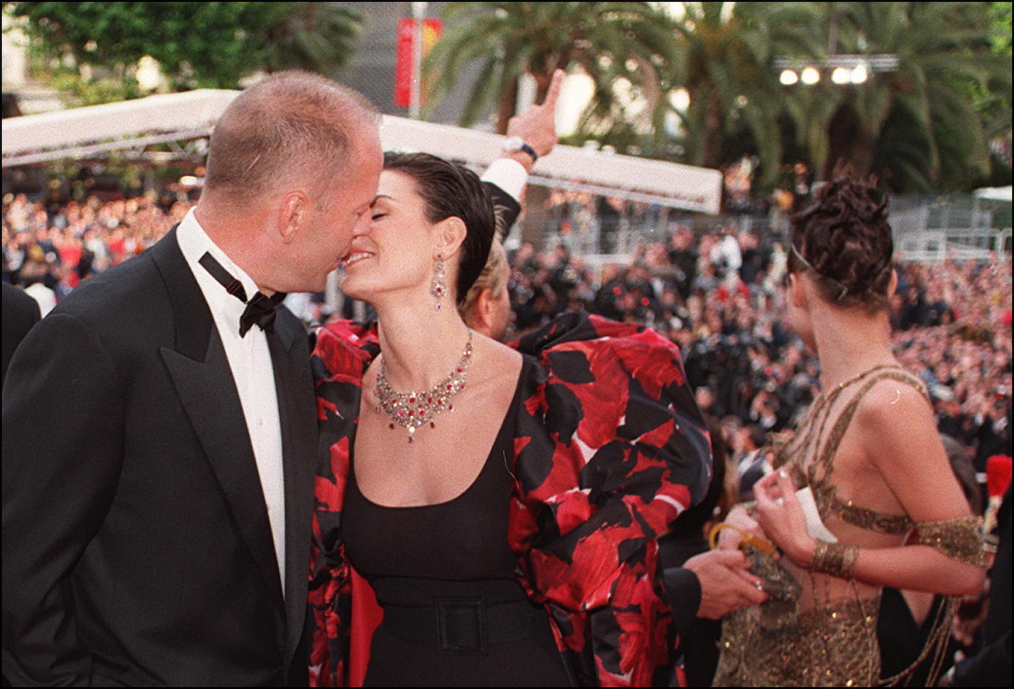 At Cannes in 1997, Bruce Willis and wife Demi Moore Bruce Willis and Demi Moore kiss at the top of the steps of the Palais des festivals