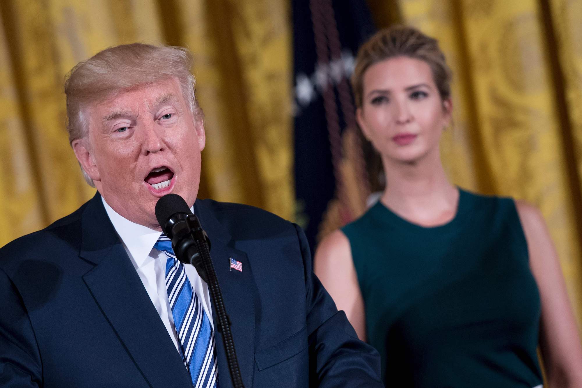 Donald Trump speaks next to his daughter Ivanka Trump