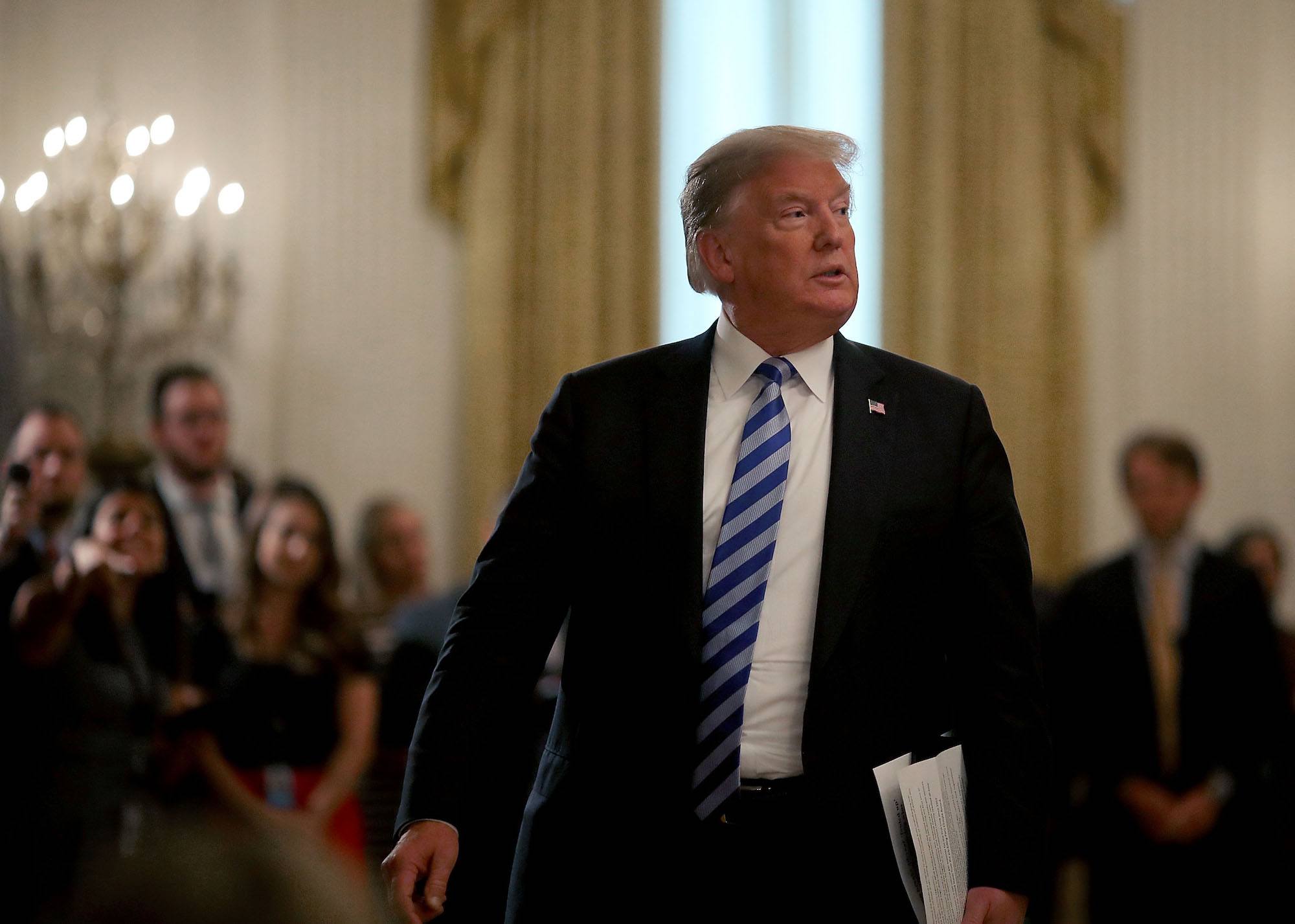 Donald Trump walks away after an event with sheriffs