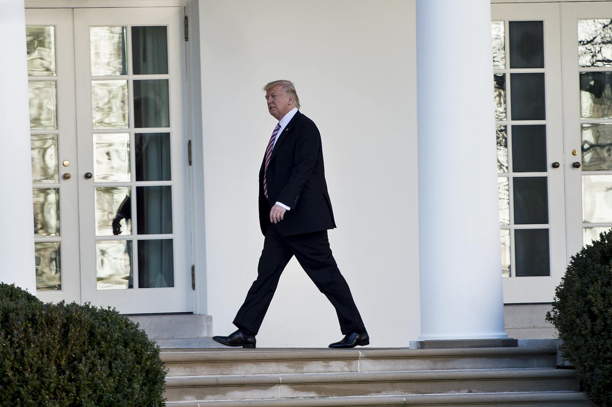 Donald Trump walks from the Residence to the West Wing of the White House