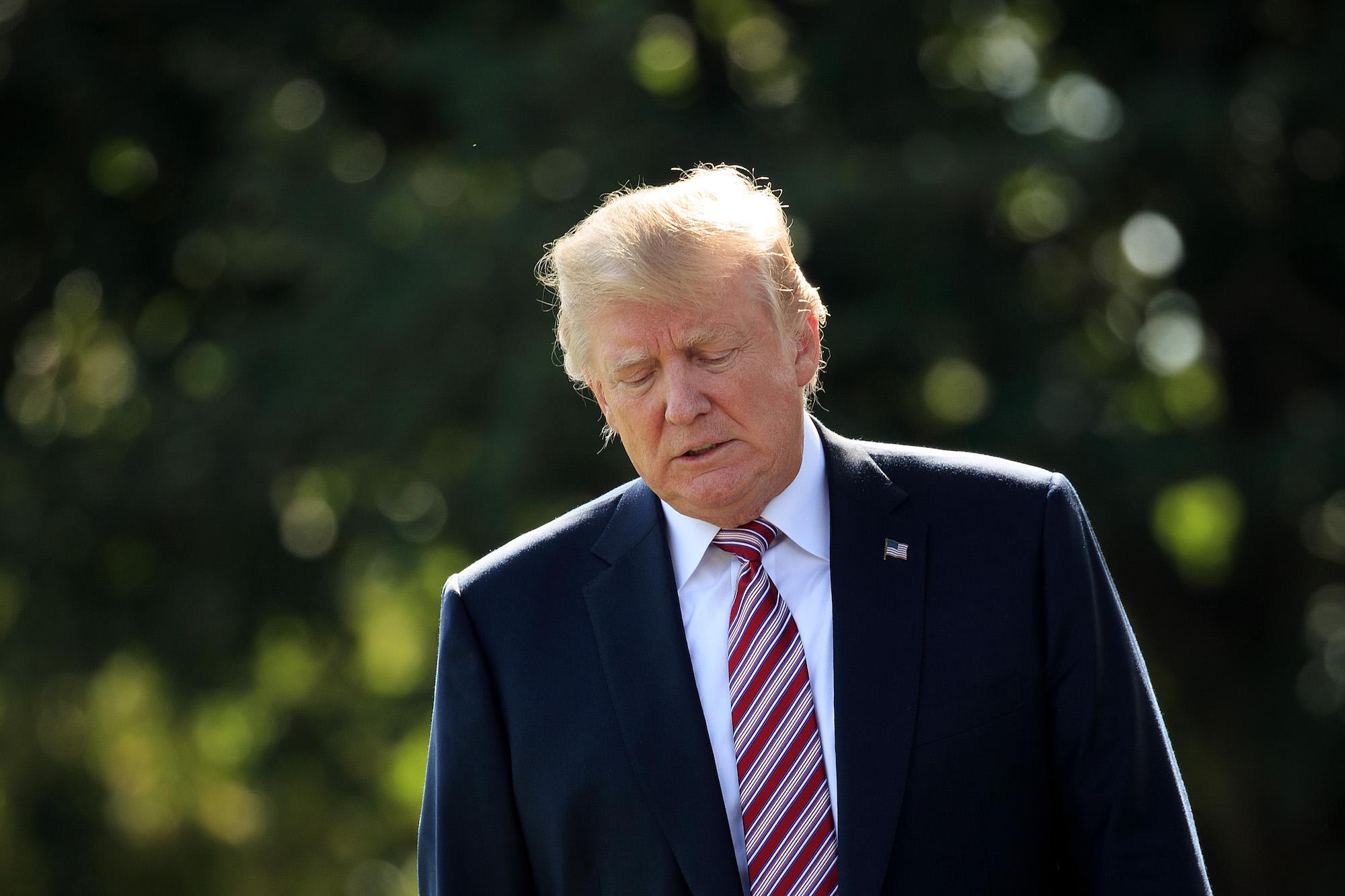 Donald Trump Donald Trump walks toward reporters before boarding Marine One on the South Lawn