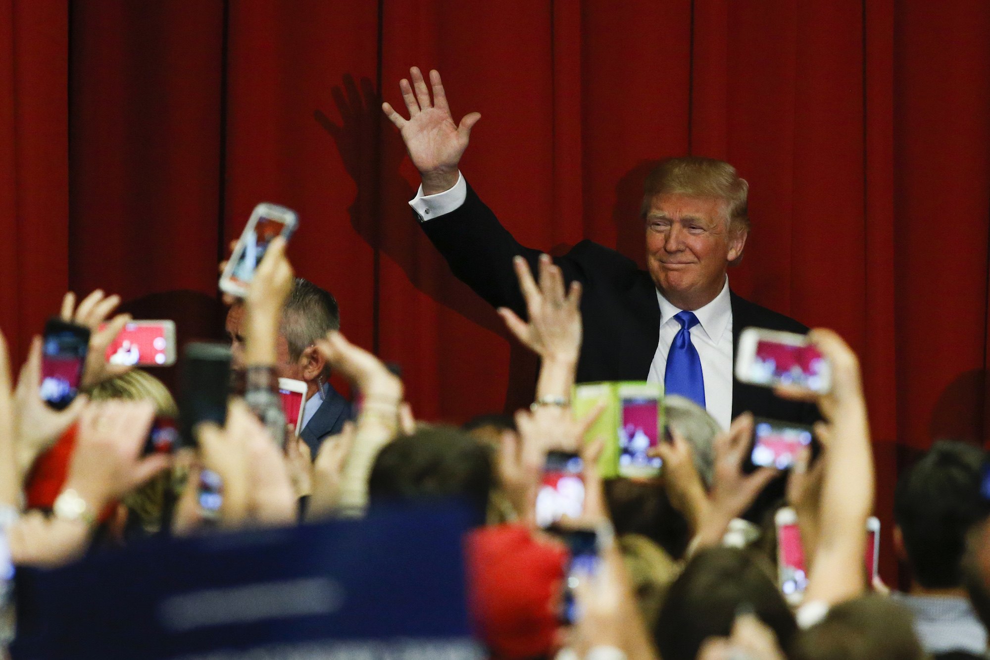 Donald Trump waves to the crowd at a fundraising event
