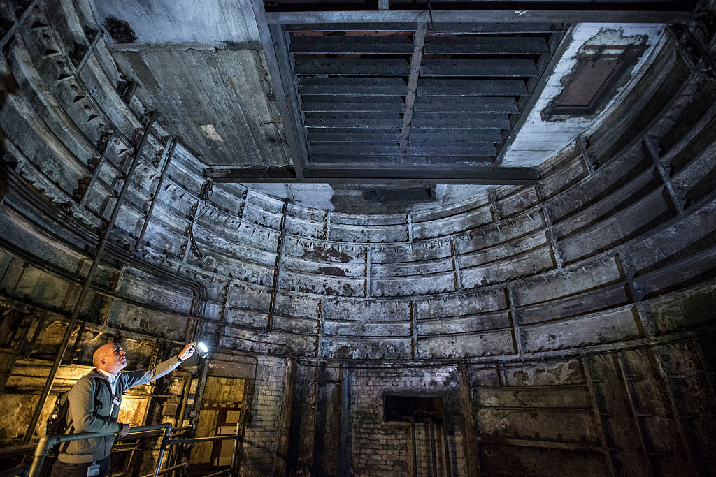 A guide illuminates part of an old lift shaft inside 'Down Street' underground station on April 13, 2016 in London, England. A guide illuminates part of an old lift shaft inside 'Down Street' underground station on April 13, 2016 in London, England.