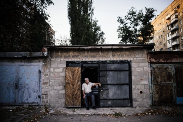 An elderly man sits in front of his garage used as a makeshift bomb shelter in Donetsk in 2014 An elderly man sits in front of his garage used as a makeshift bomb shelter in Donetsk in 2014