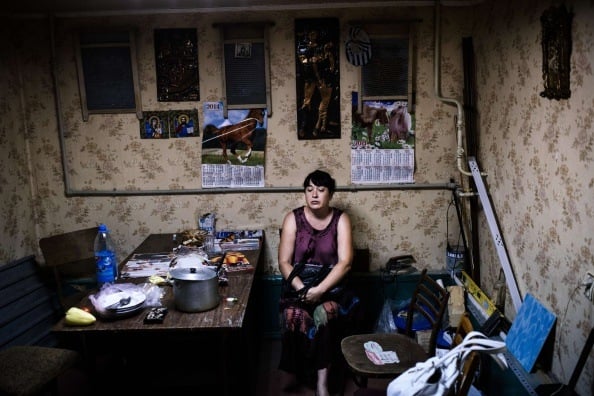 A woman sits inside a makeshift bomb shelter in Donetsk, on August 10, 2014.