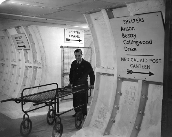 A man with a trolley stretcher in the London Underground shelters A man with a trolley stretcher in the London Underground shelters