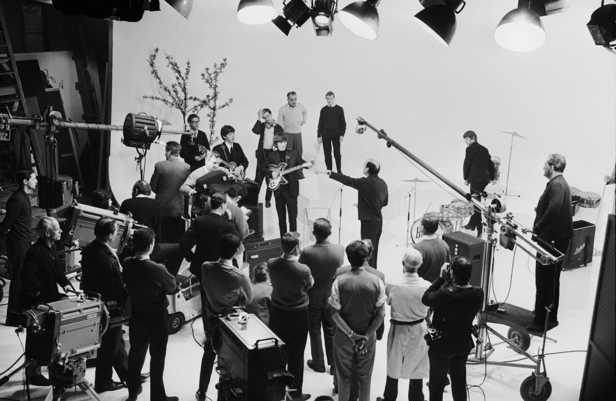 The Beatles prepare to play in a television studio